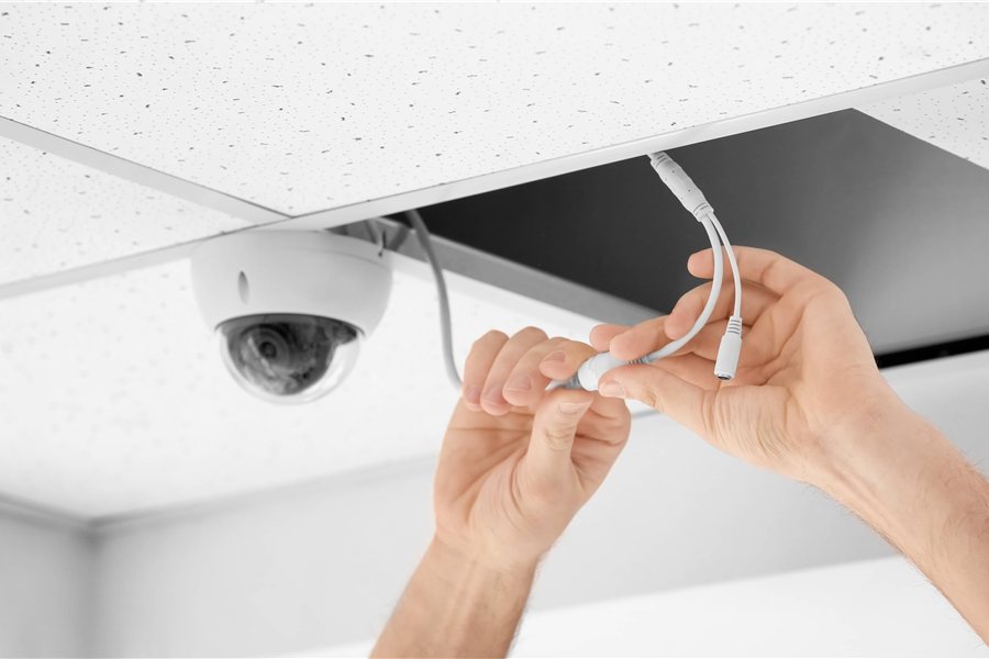 Technician connecting low-voltage security cabling